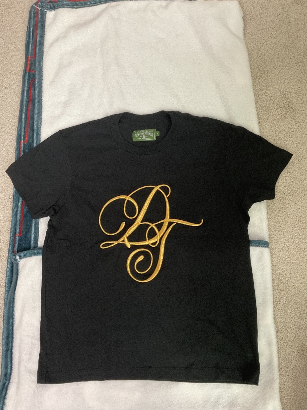 Denim Tears black signature t-shirt with gold cursive 'DT' logo, size Small
